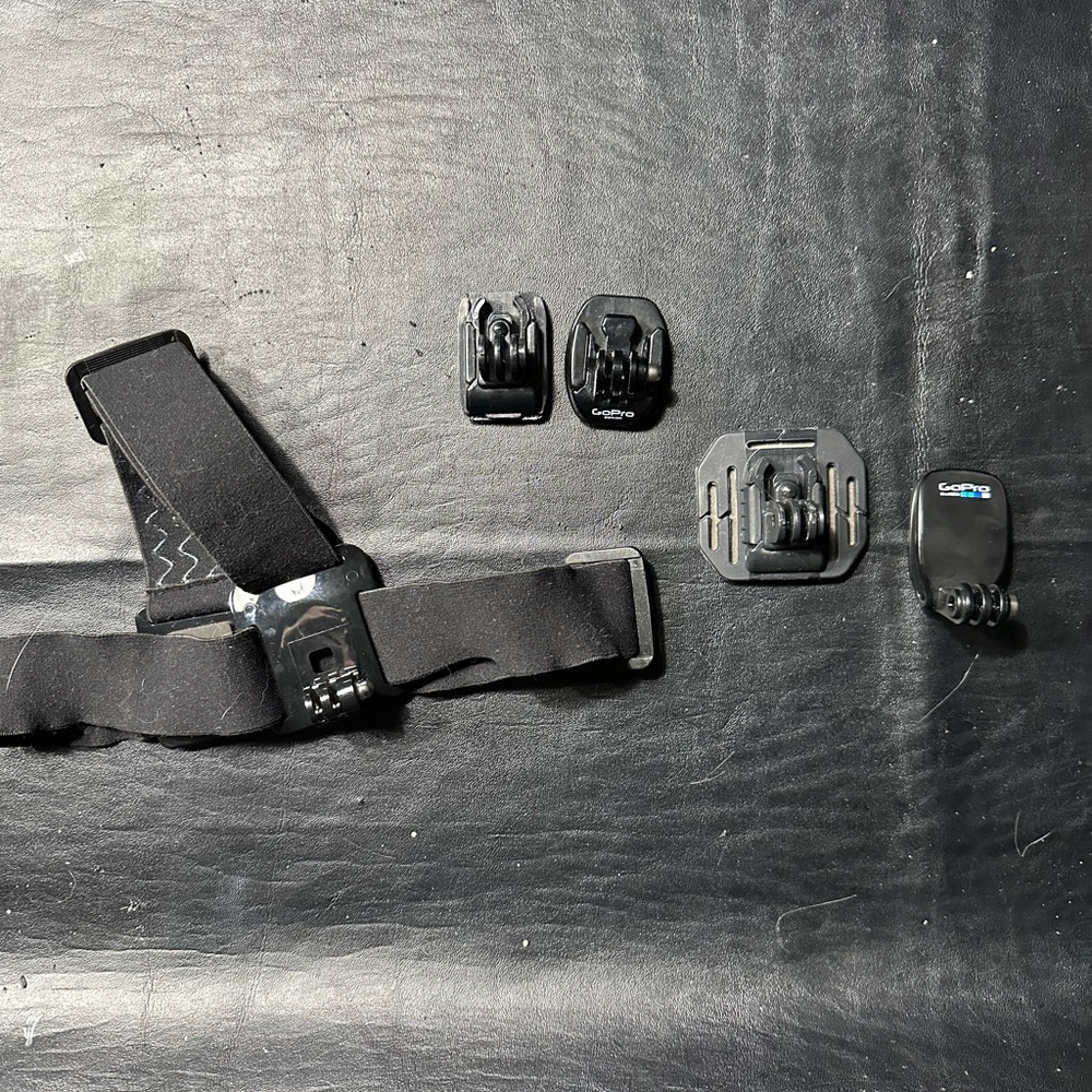 Bundle of Go Pro Head Mount, 3 Stick Mounts , Clip, Charger and Thumbscrews